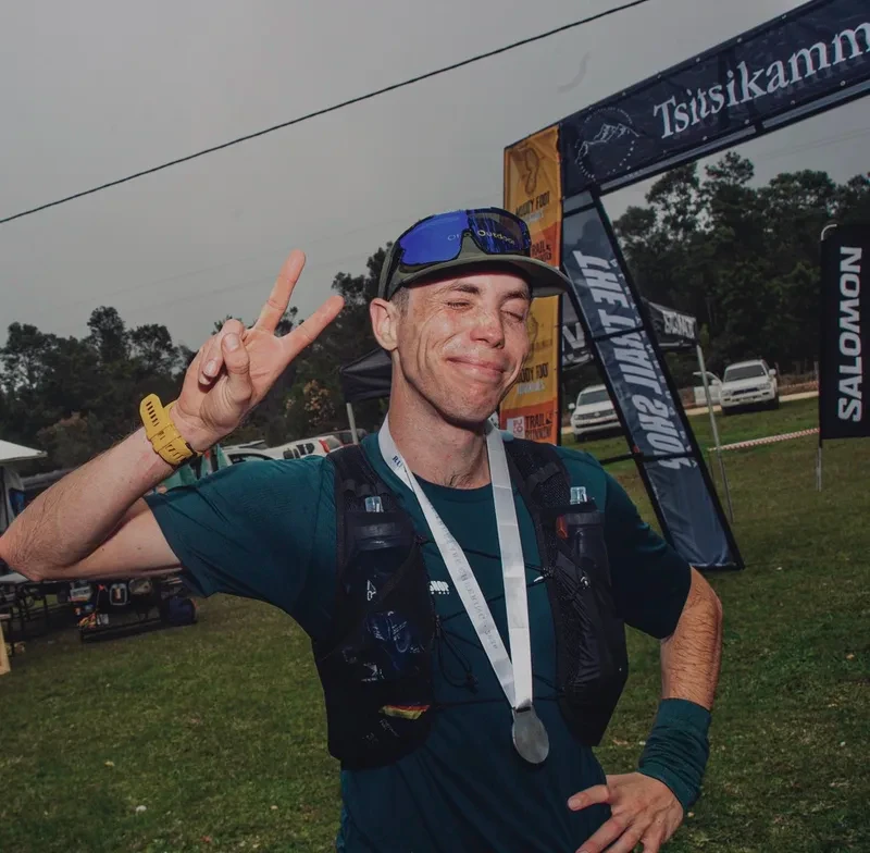 Finisher with a medal under the Tsitsikamma arch